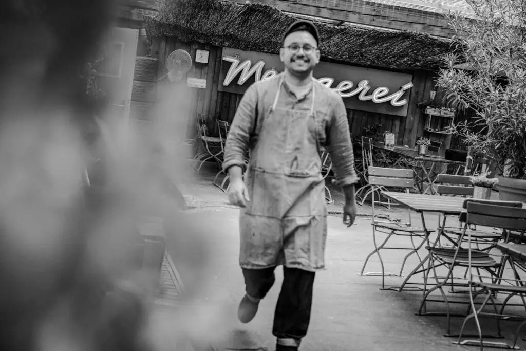 Mitarbeitender der Metzgerei Hornung läuft Freude strahlend durch den Innenhof