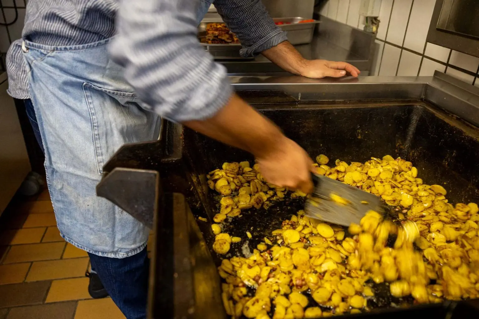 Zubereitung von Bratkartoffeln in der Produktionsküche der Metzgerei Hornung